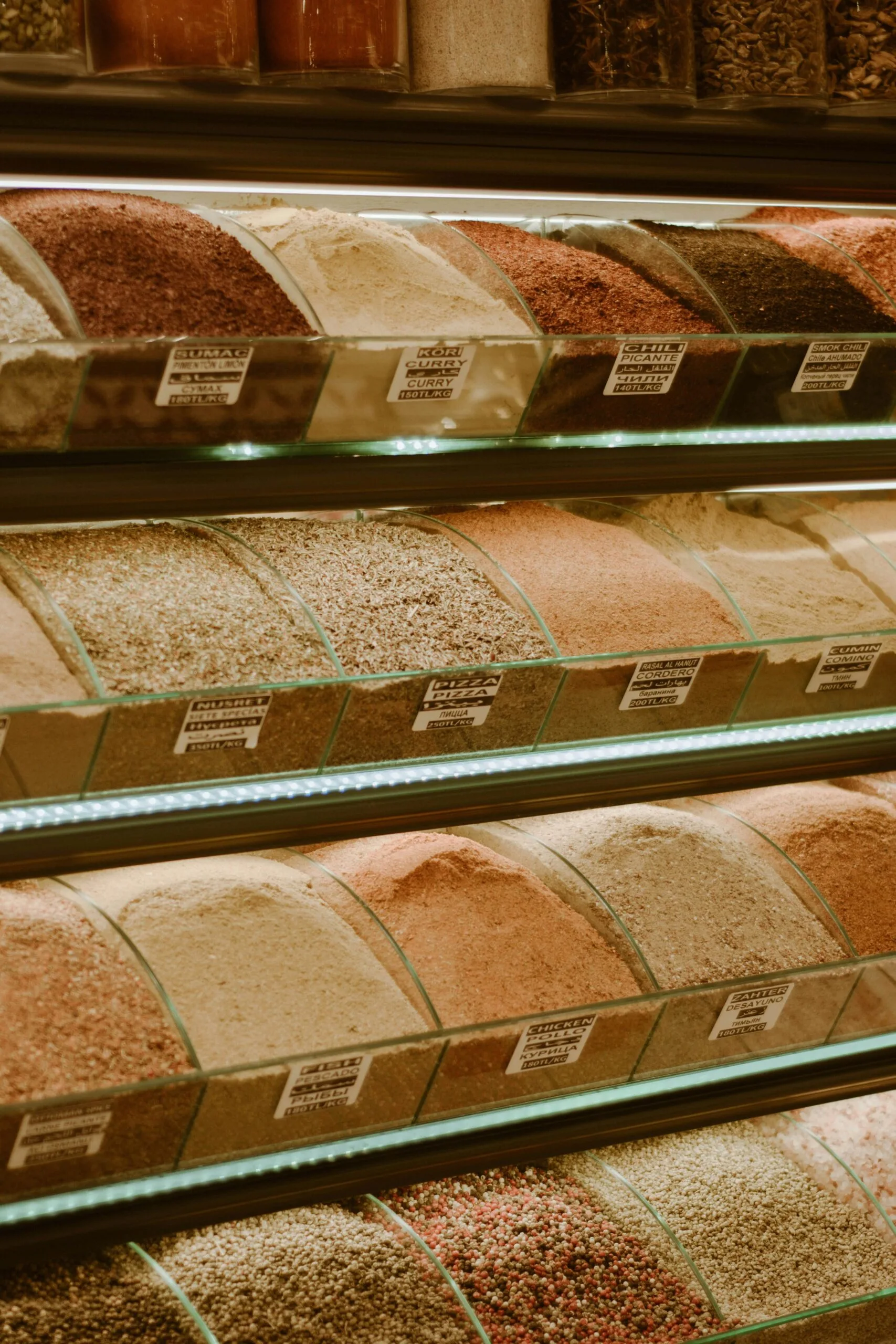  A shelf displaying an array of colorful spices in a spice store located in Sharjah, showcasing diverse culinary options